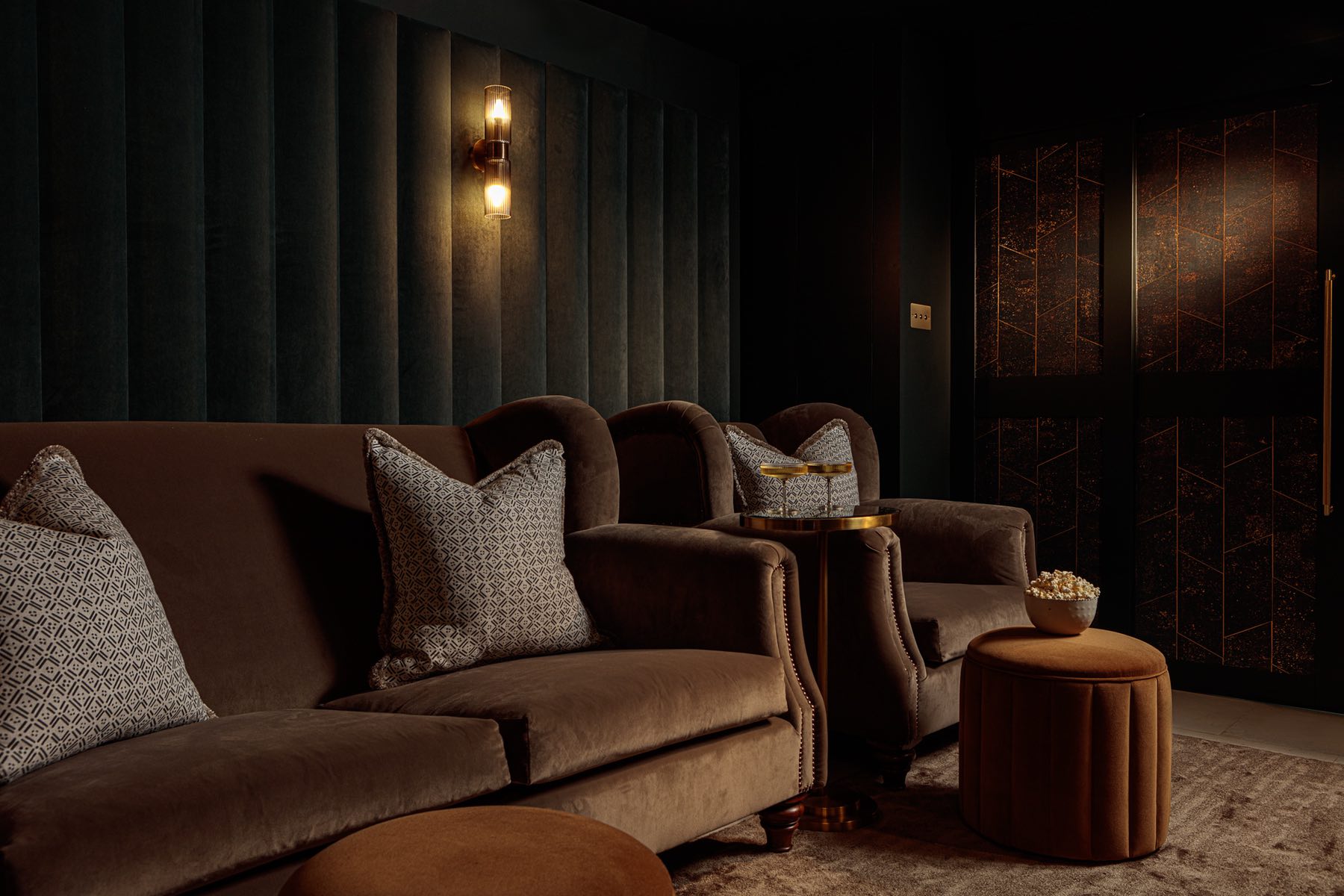 Dark tones velvet cinema room with luxurious armchairs and cocktail table