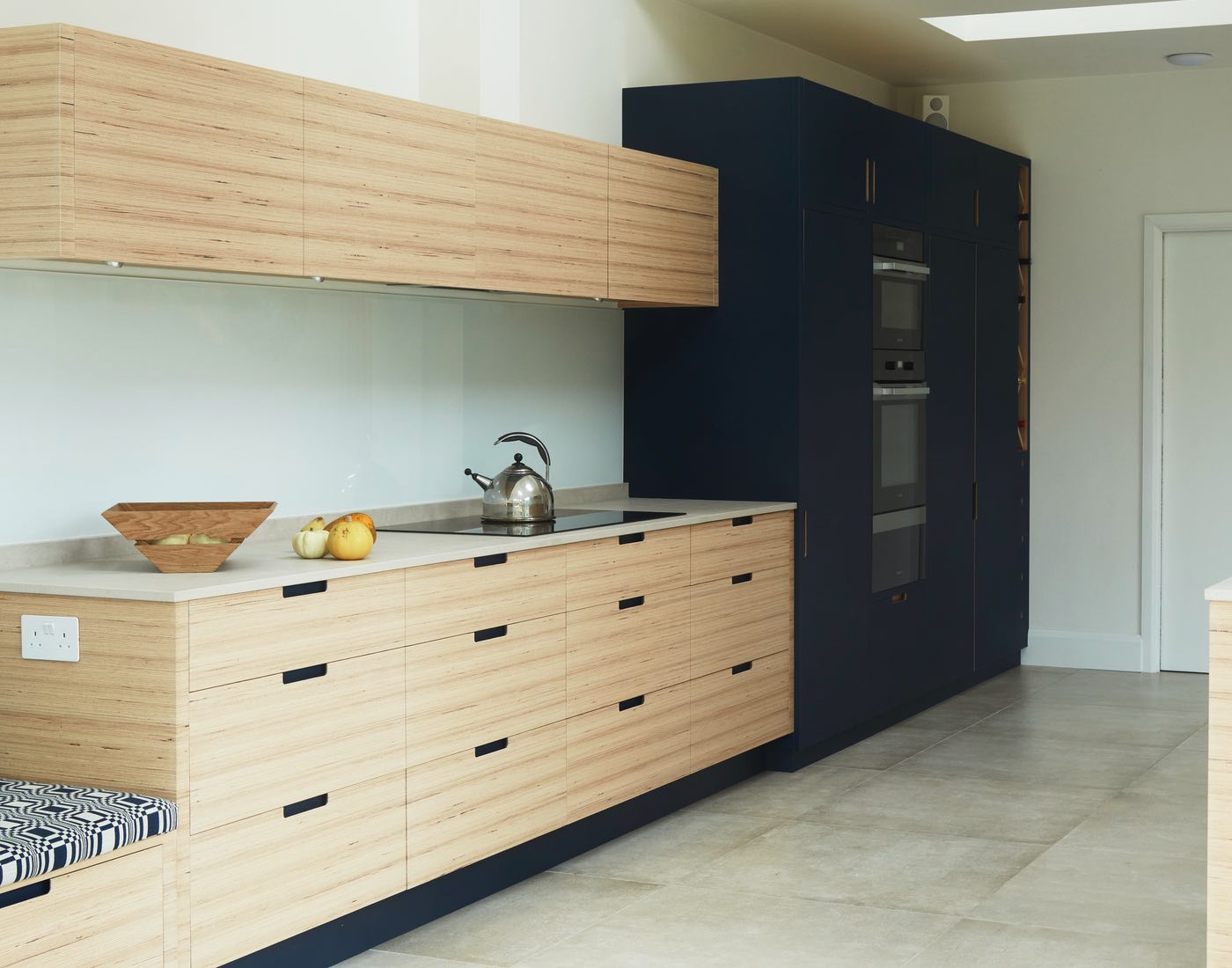Scandi inspired kitchen with wood and navy cupboards