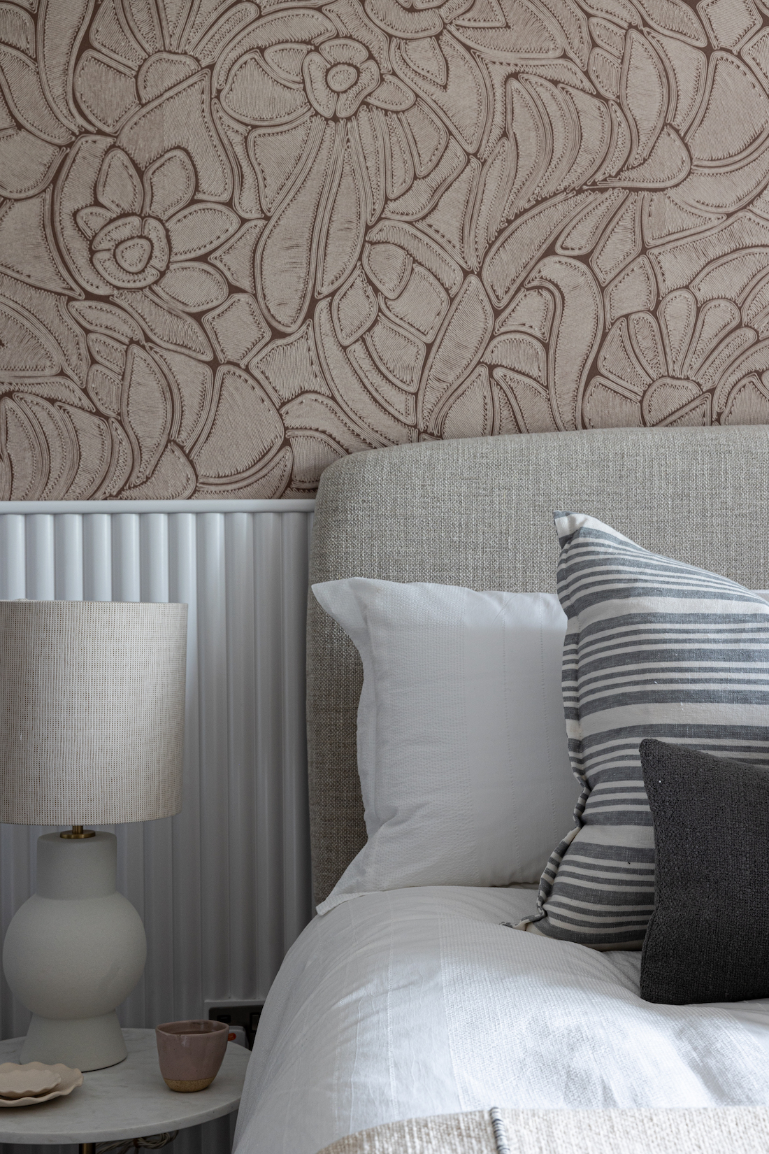 urban contemporary bespoke bedroom design with bespoke headboard, bespoke fluted wall joinery and rope texture fabric wallcoverings