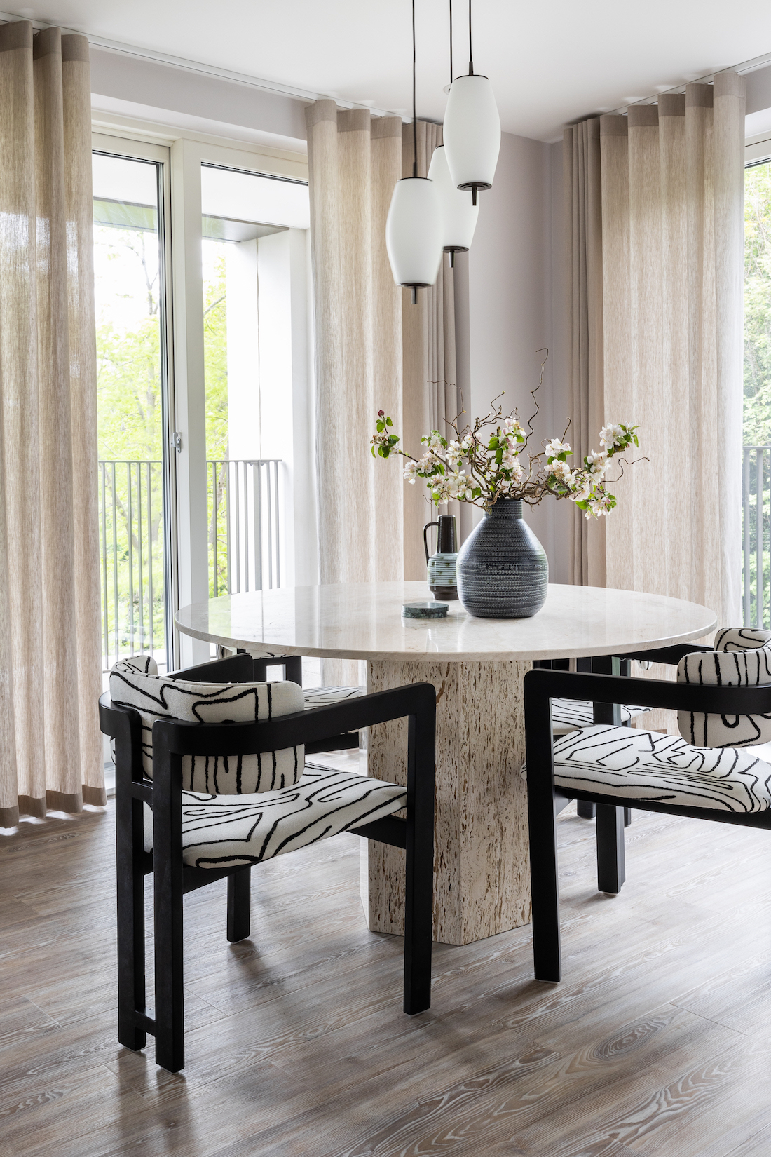 urban contemporary neutral apartment dining table geometric black and white chairs with travertine stone octagonal table