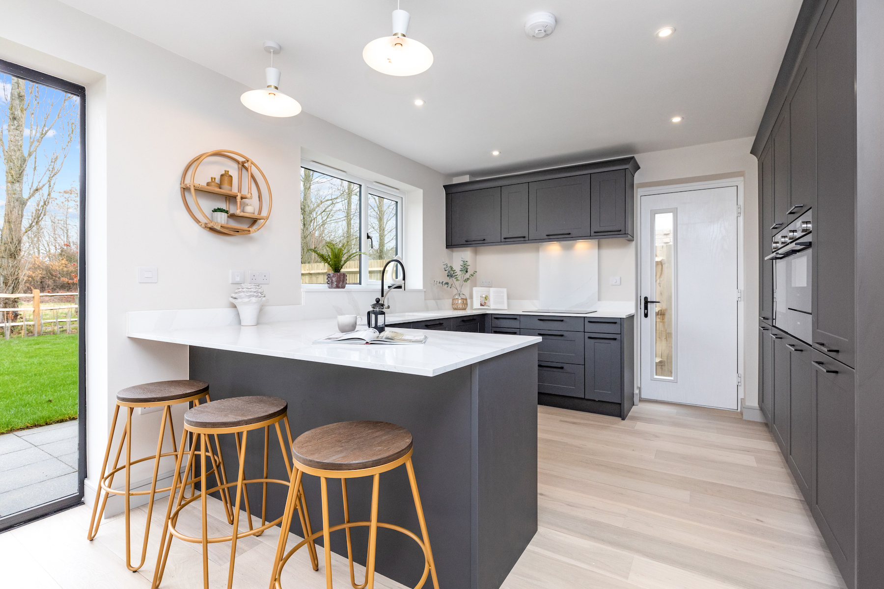 Suburban Development in Mid Sussex Countryside Kitchen and Dining with breakfast bar and bar stools