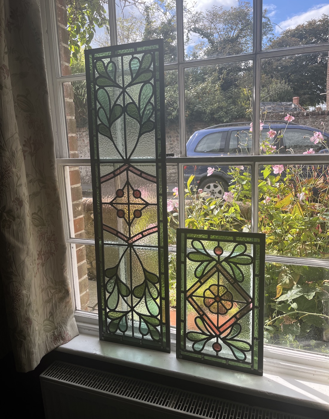 Bespoke stained glass window, design by Pfeiffer Design working with our stained glass window artisan to pick colours and patterns. Colour scheme is pinks and greens, reflecting the feminine aesthetic of the home